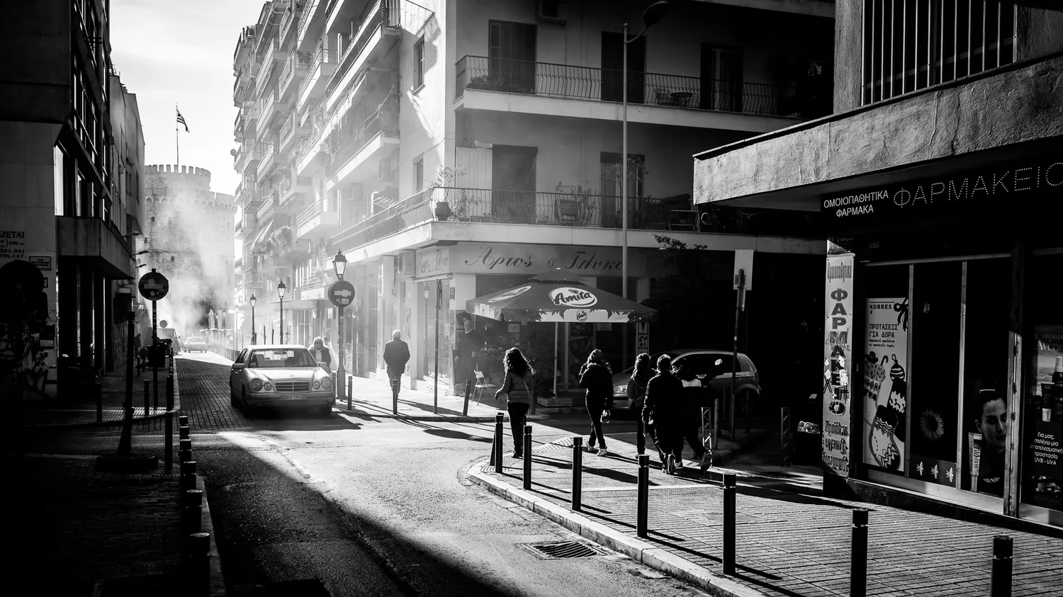 The White Tower at the end of a small street in Thessaloniki, Greece